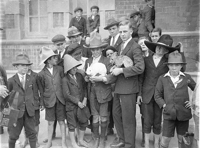 schoolboys being shown rabbits and hat 1927